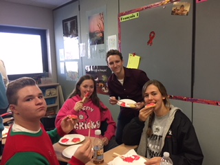 classroom full of happy students eating cookies